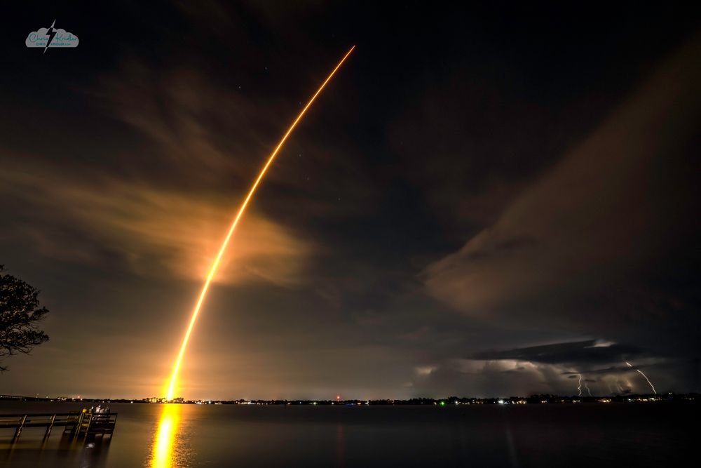 Falcon 9 rocket with the Fram2 polar orbit mission launches over a line of lightning storms on March 31, 2025, from Kennedy Space Center.