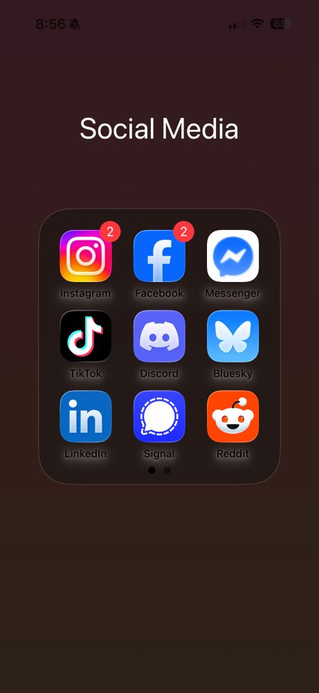 Ios26 folder with social media icons.  Below each icon is the app name with a white blurry background behind it.