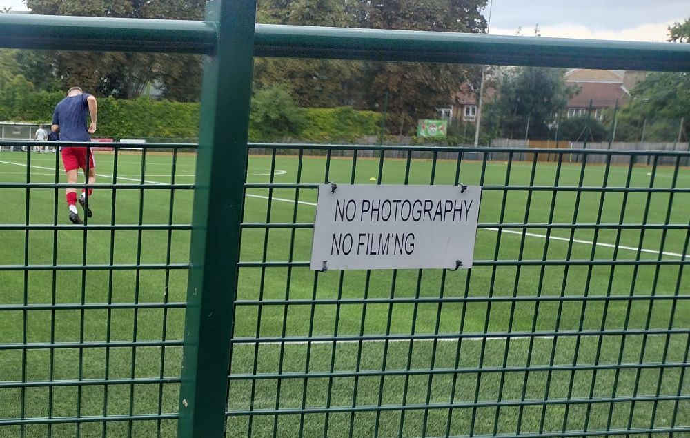 Sign in front of a football pitch saying NO PHOTOGRAPHY NO FILM'NG