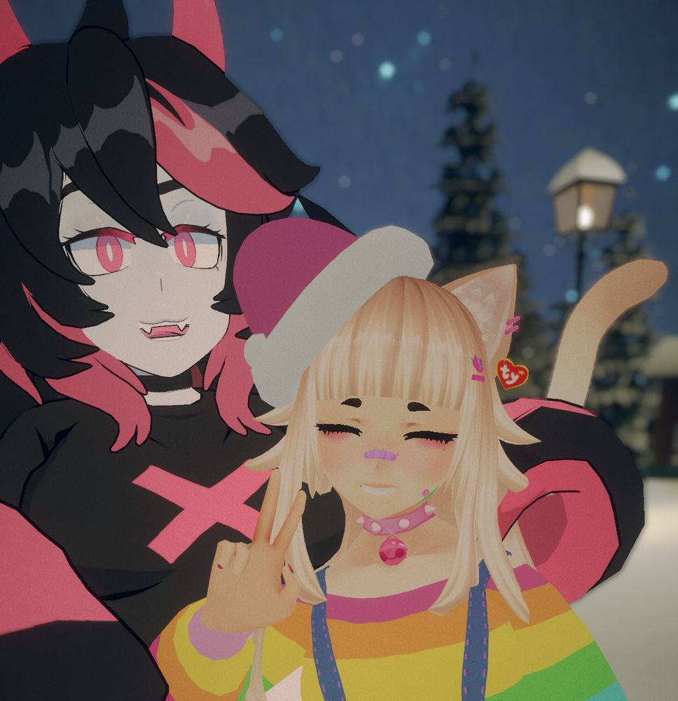 Two vtubers pose together outdoors at night, with a snowy background. One has pink and black hair (andou); the other has light blonde hair and wears a Santa hat and rainbow outfit (fortune).