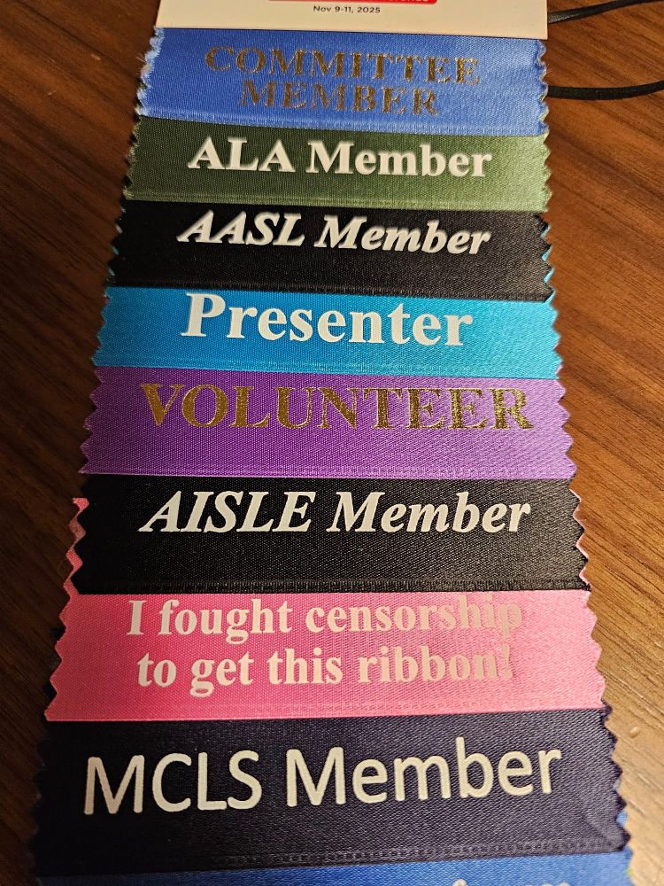 A row of conference ribbons.