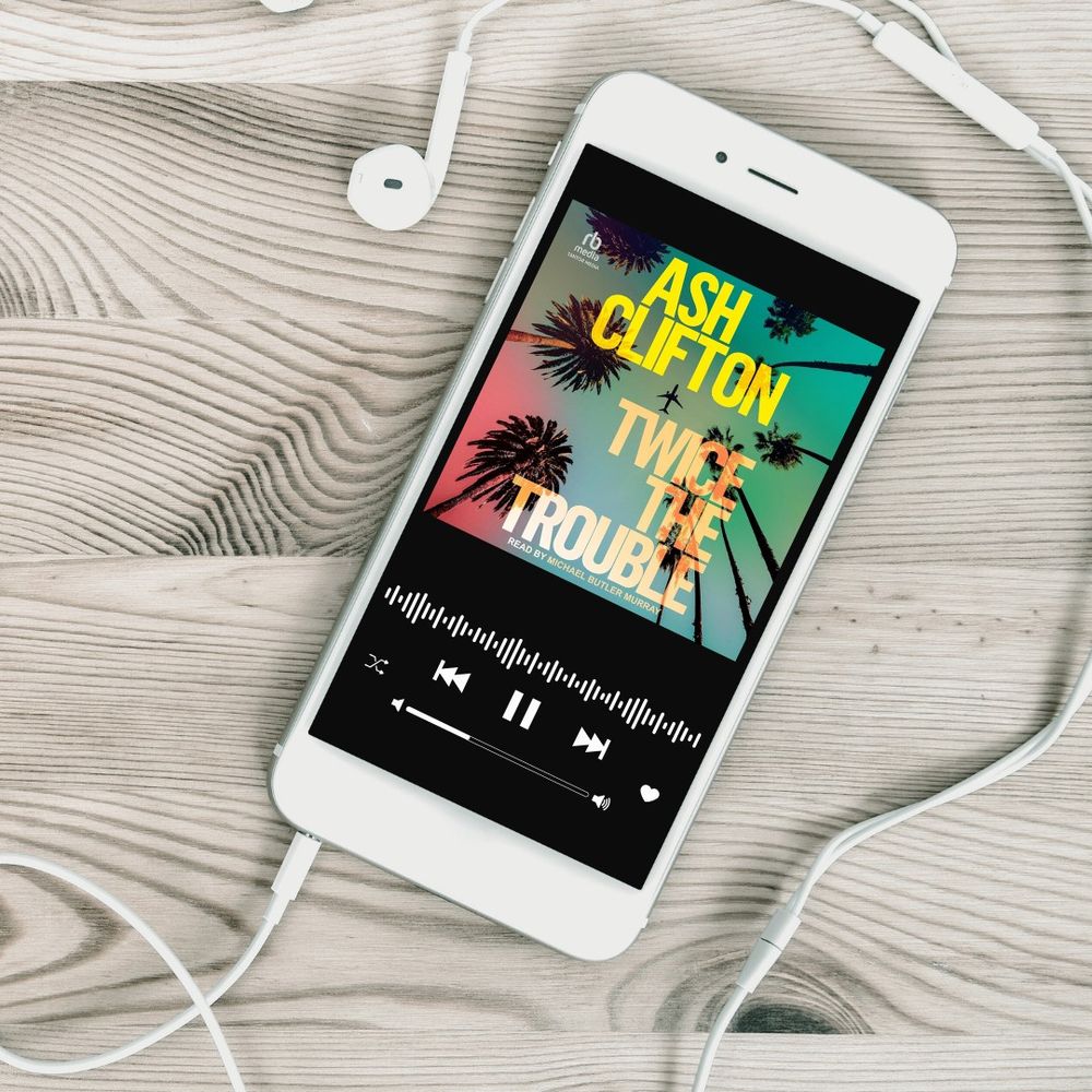 A picture of a phone with the audiobook Twice the Trouble by Ash Clifton