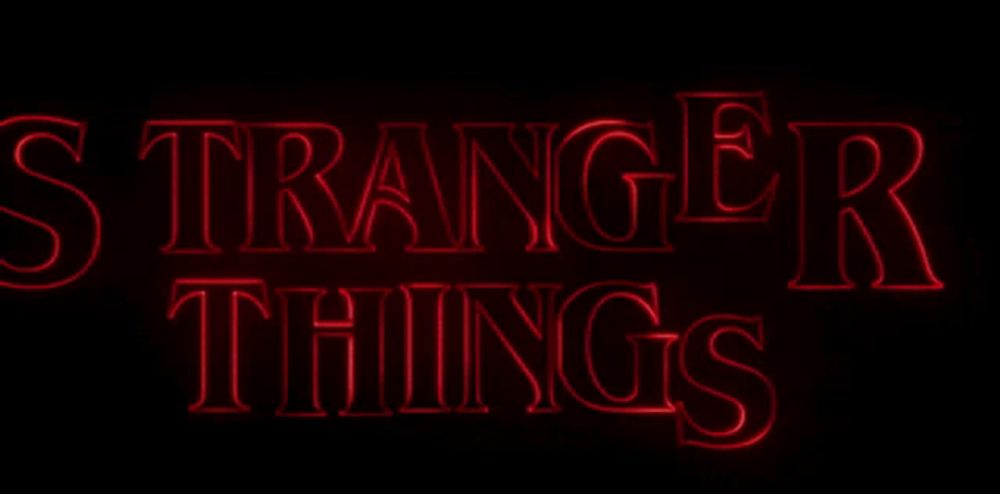 a red neon sign that says stranger things