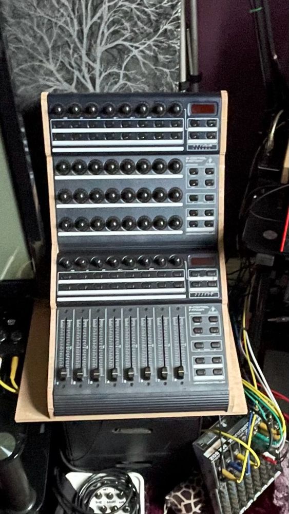 A pair of Behringer BCR2k control surfaces vertically mounted in a home made wooden frame