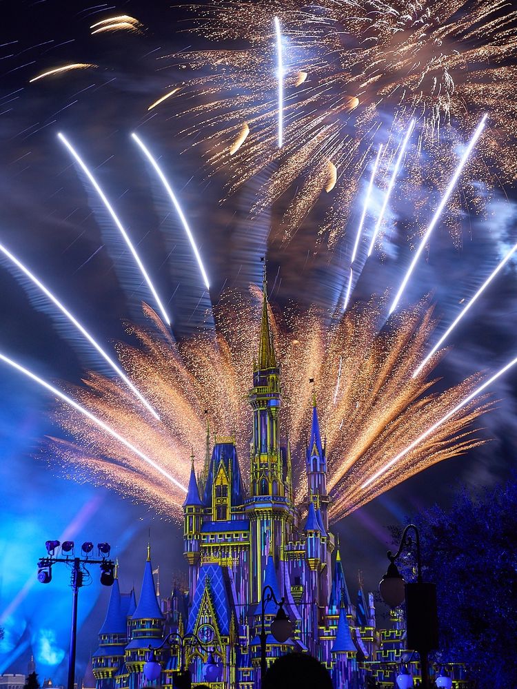 A color photo of fireworks behind Cinderella’s Castle at the Magic Kingdom.