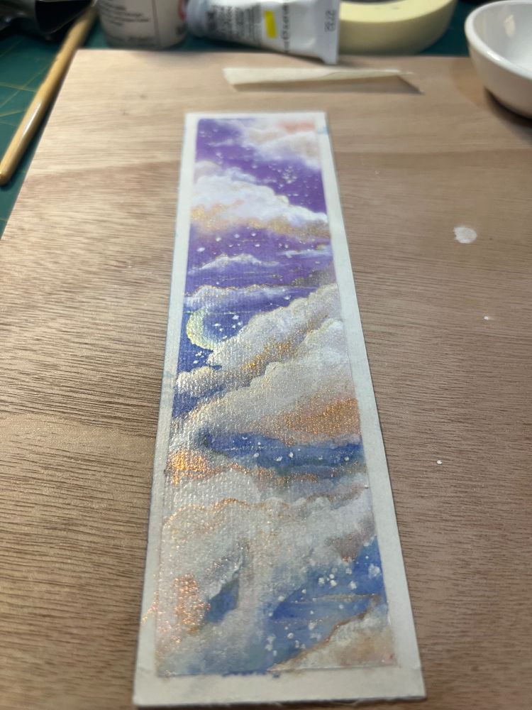 A bookmark with a watercolor sky