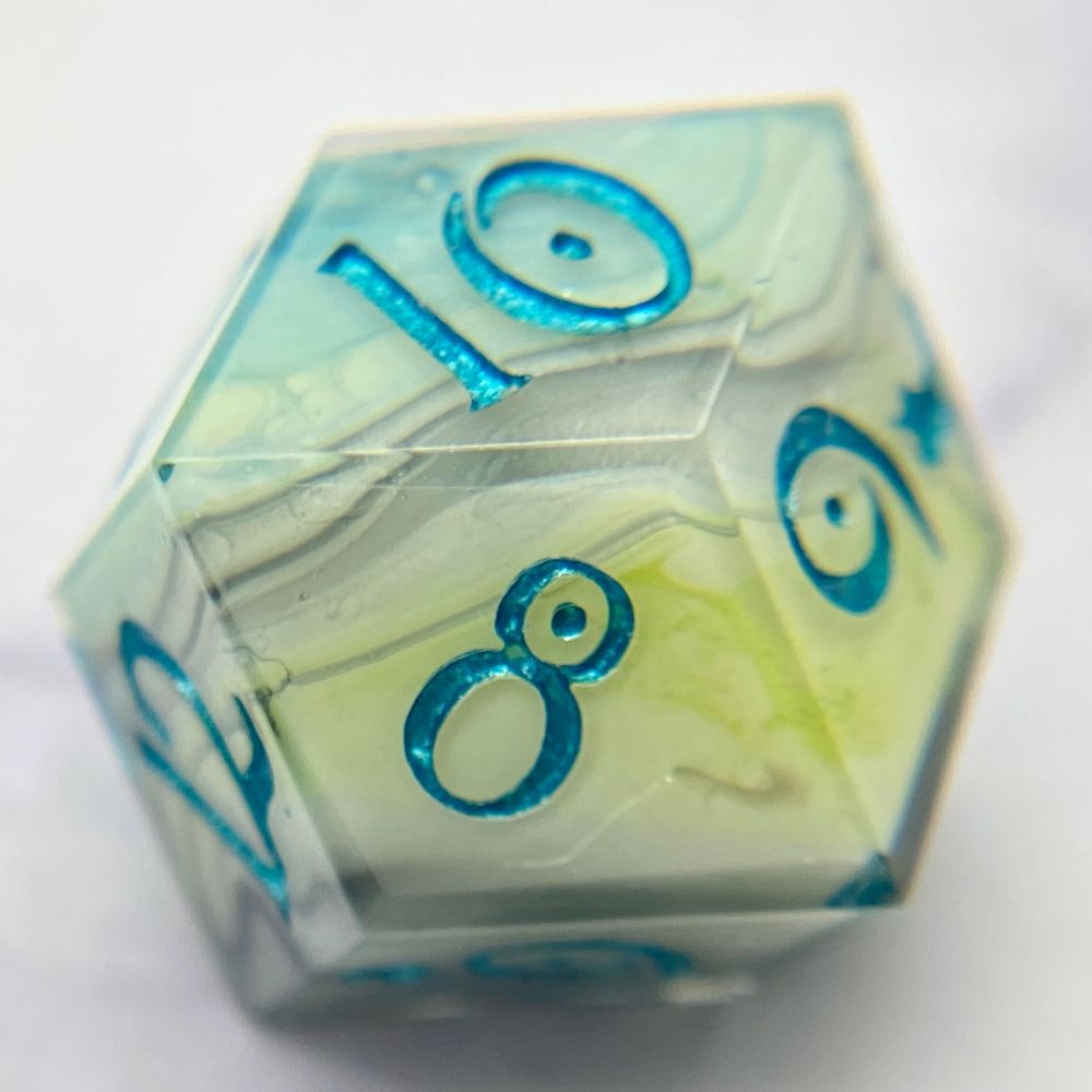 A rhombic d12 that has a white base, with swirls of black, lime green, and teal blue, inked in a metallic teal. 