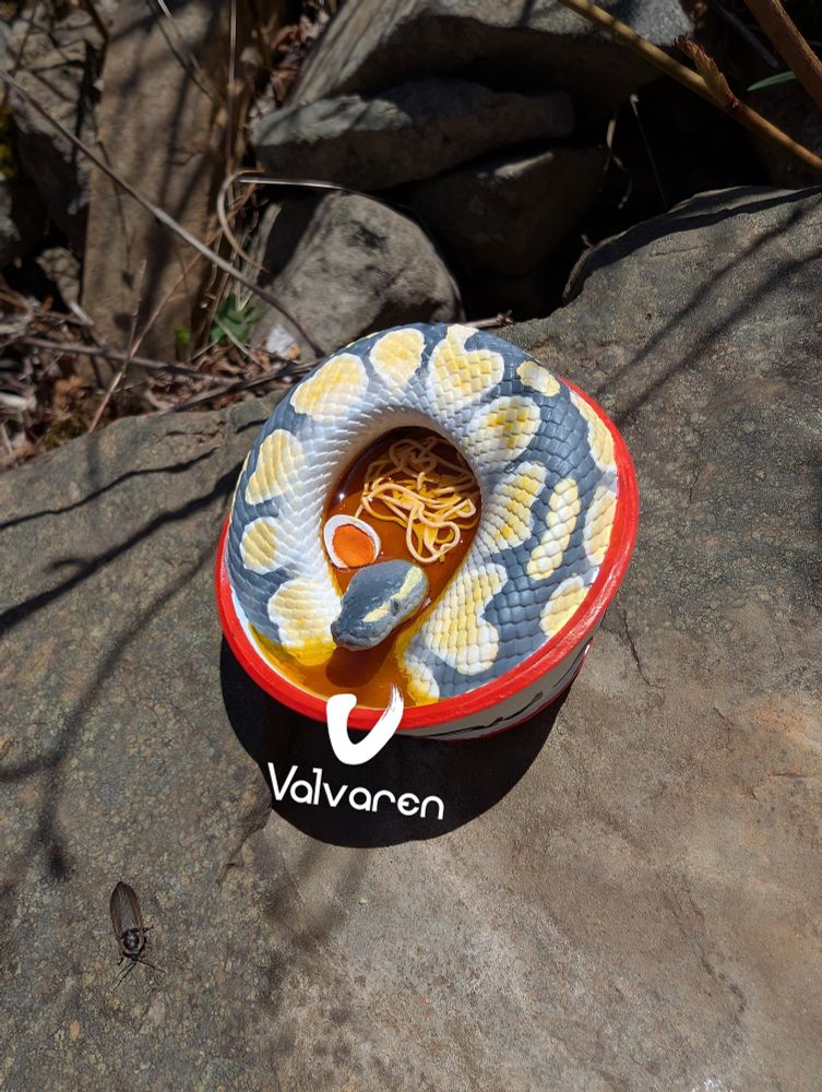 Ball python in a ramen bowl figurine.