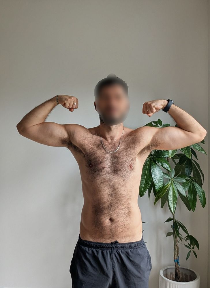 Me flexing in my regular corner in front of two plants