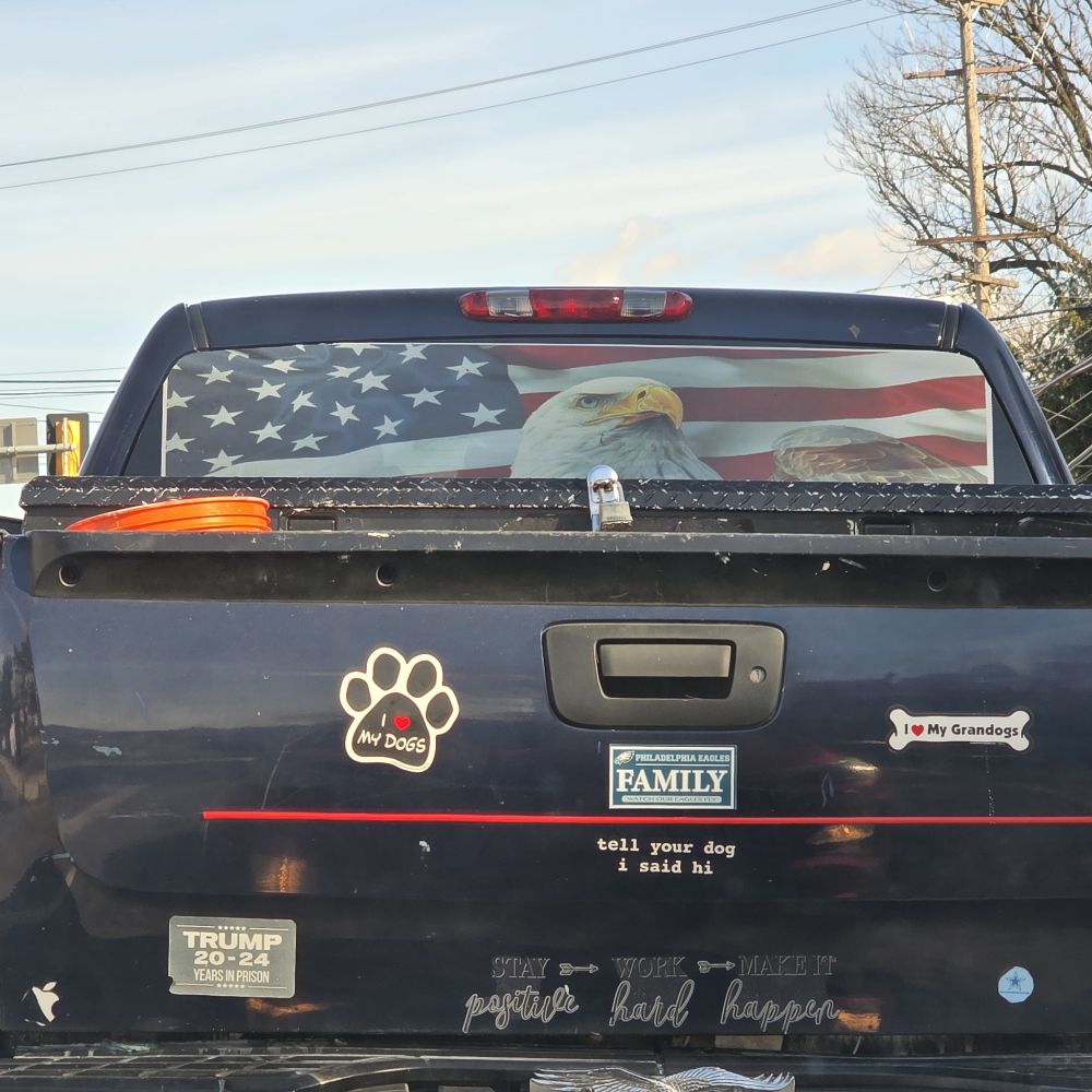 flag-laden pick up truck... with a Trump for prison sticker
