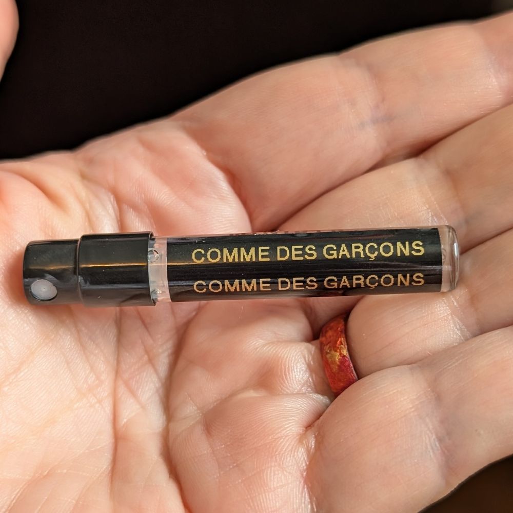 Small vial of Comme des Garçons (2011) in my hand. Scent notes: aldehydes, Safraleine, hawthorn, lilac, industrial glue, brown sticky tape, vinyl, musk and styrax.