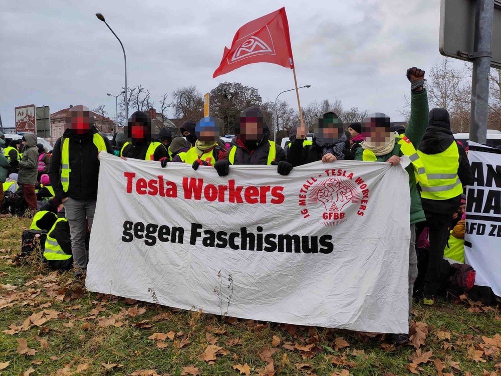 German Tesla workers carrying an IG Metall banner with translated slogan "Tesla Workers Against Fascism" from demonstration on 11 January 2025 in Riesa, Saxony, Germany
