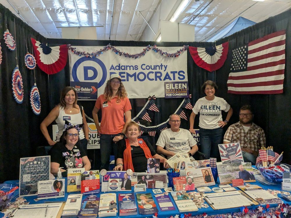Amie at a booth with other Democrats