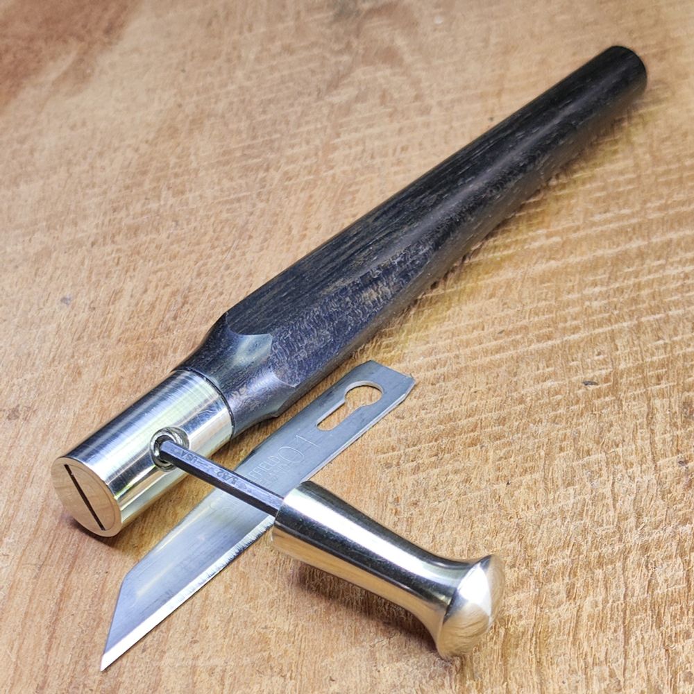Detail of PersonMakeObject craft knife illustrating the blade holder hardware and integrated blade wrench. 