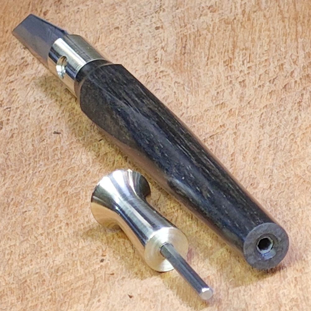 Detail of PersonMakeObject craft knife illustrating socket for storage of integrated blade wrench (a rare earth magnet at the base of the socket holds the wrench in place).