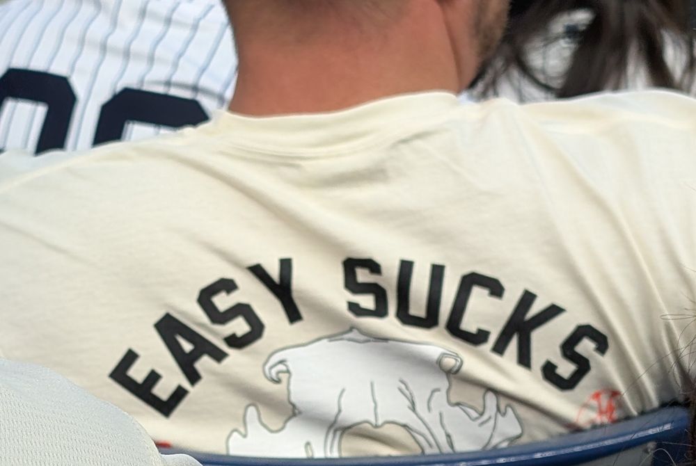 Man wearing T-shirt with the words "EASY SUCKS"