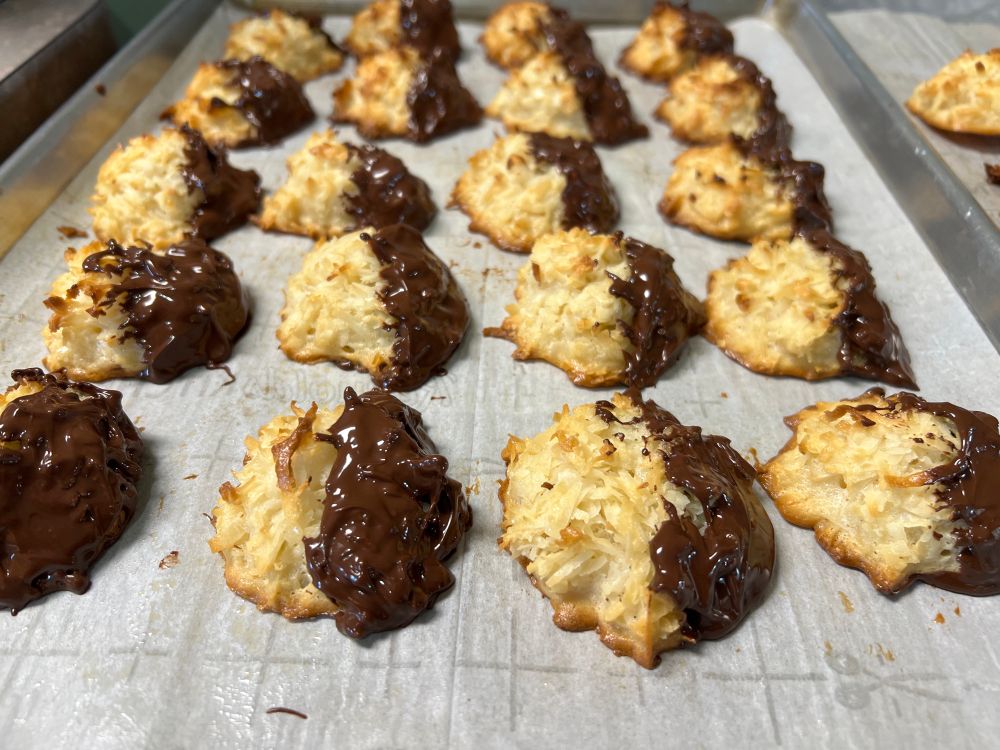 Photo of the previously quote posted macaroons after being half-dipped in chocolate. 