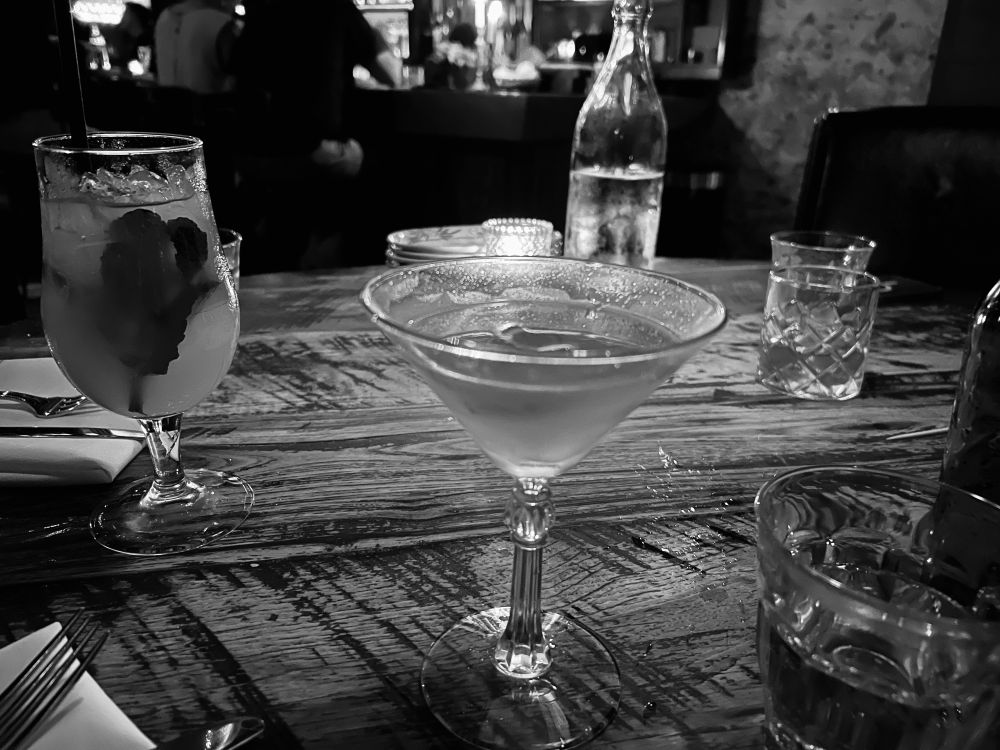 Black and white photo of drinks on the table pre-dinner. 