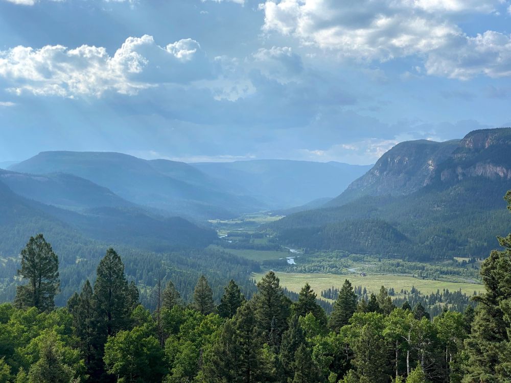 A valley of the rio grande, it’s cloudy but you can see the light shine through the clouds in a heavenly display 