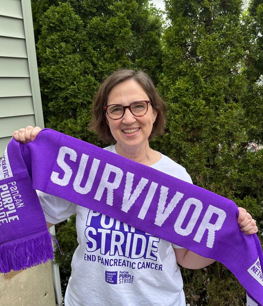 Me holding a pancreatic cancer survivor scarf