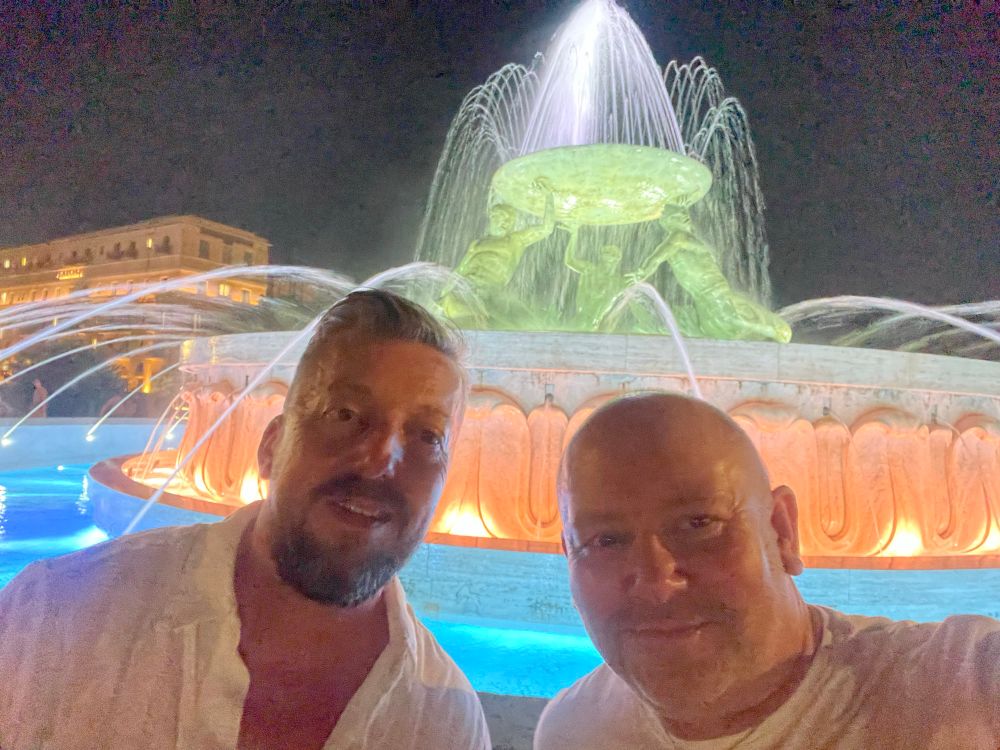 Greg and myself in front of the Triton Fountain lit up at night