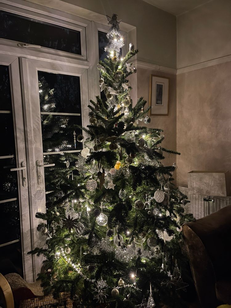 Real Christmas tree with silver, white and clear decorations
