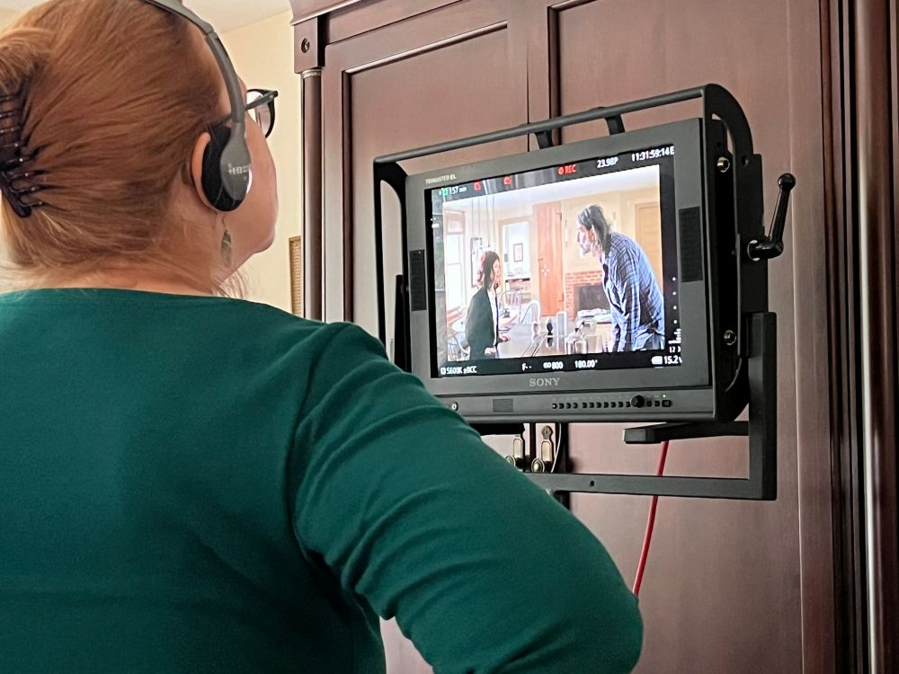 Sarah Knight looking at a monitor while directing Irving Berlin's View of the East River