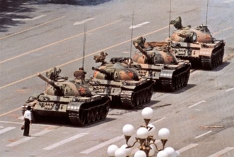 "Tank Man" temporarily stops the advance of four Type 59 tanks on June 5, 1989, in Beijing. This photograph (one of six similar versions) was taken by Jeff Widener of the Associated Press.