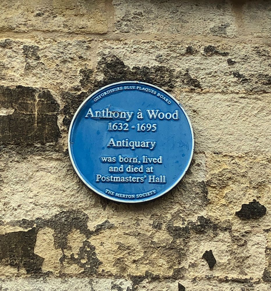 A blue plaque dedicated to the 17thC antiquarian Anthony a Wood. It says he was born, lived, and died at Postmasters' Hall, Oxford. 