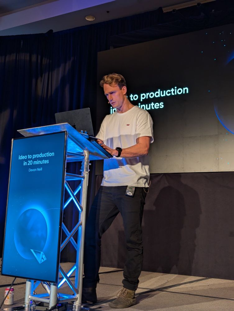 Devon Neil on stage at Epic Web Conf live vibe coding