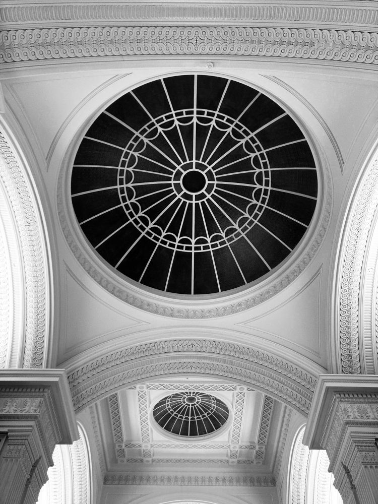 Black & white photo of the beautifully-proportioned neoclassical circular domed ceiling and decorative arches at the Talbot Rice Gallery, University of Edinburgh, Scotland.
