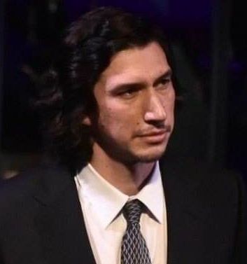 adam driver long hair short facial hair black suit white shirt patterned dark tie