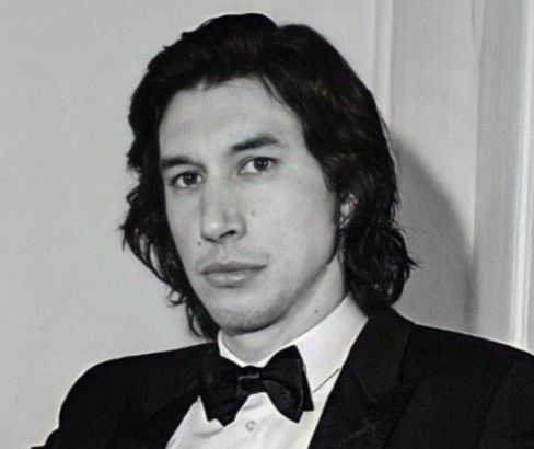 adam driver lounding in a tux