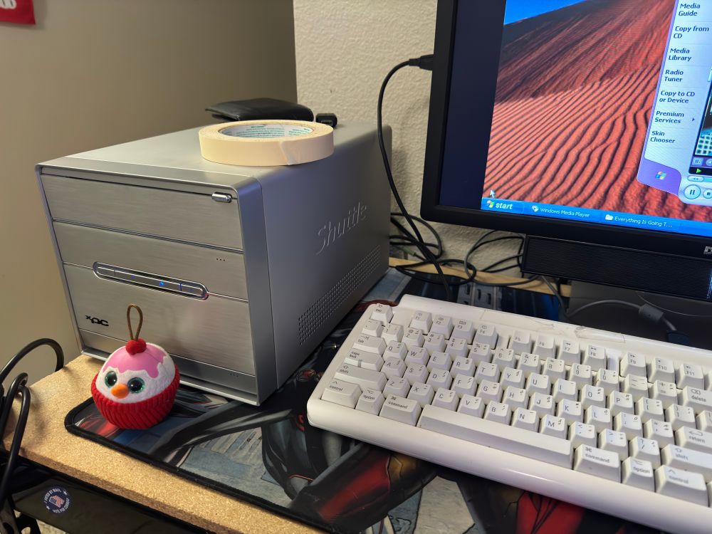 A silver Shuttle SS30G2 on a “desk” with a keyboard