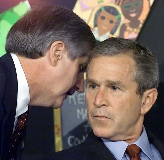 An aide telling George Bush a second plane has struck the world trade center