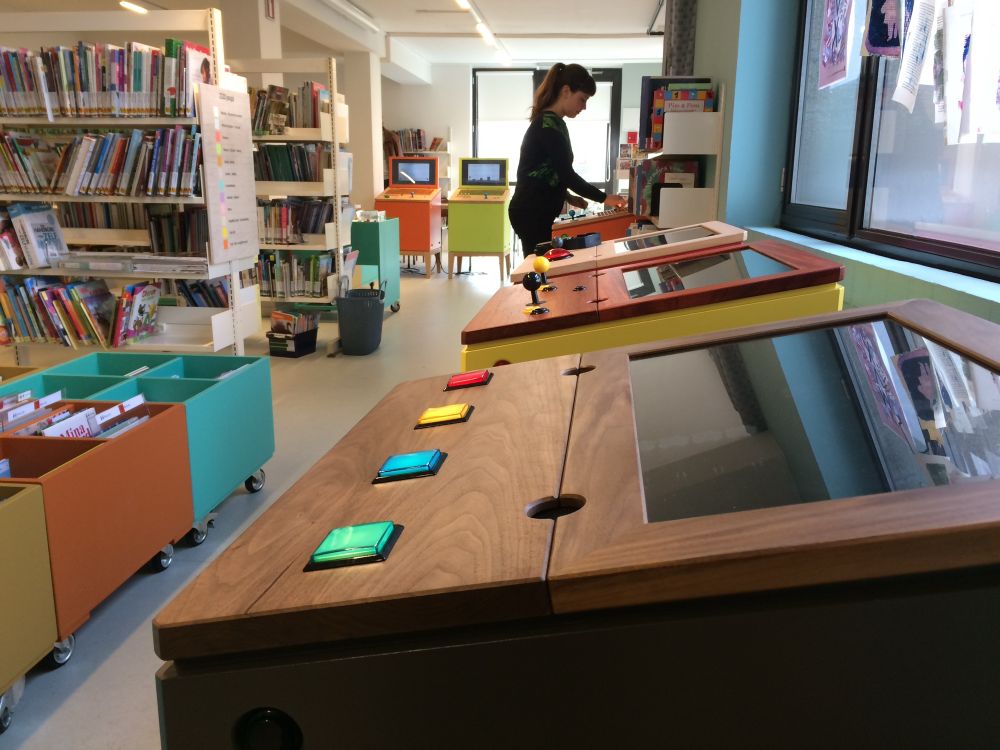 wooden arcade cabinets in a library