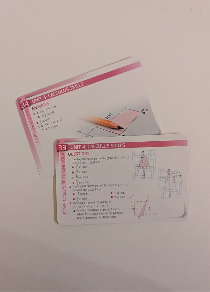 A photo giving a closer look at BrightRED's Higher Mathematics Revision Cards, specifically cards 33 and 34, which cover calculus skills.