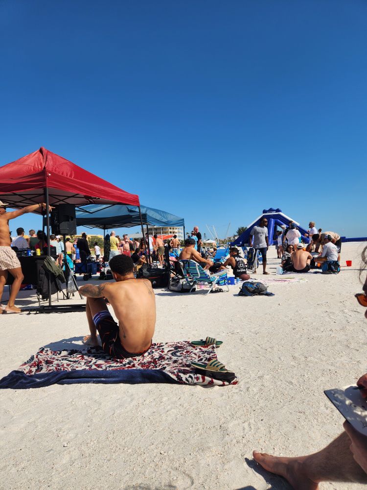 A gathering of people on the beach.