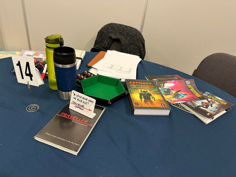 Table ready for play with Traveller and Cepheus Universal rules, and Scoundrels of Brixton zines. And some drinks. 