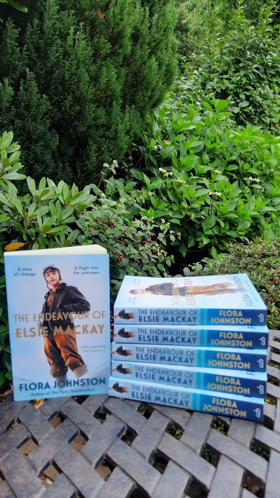 Paperback copies of the novel The Endeavour of Elsie Mackay on a garden table