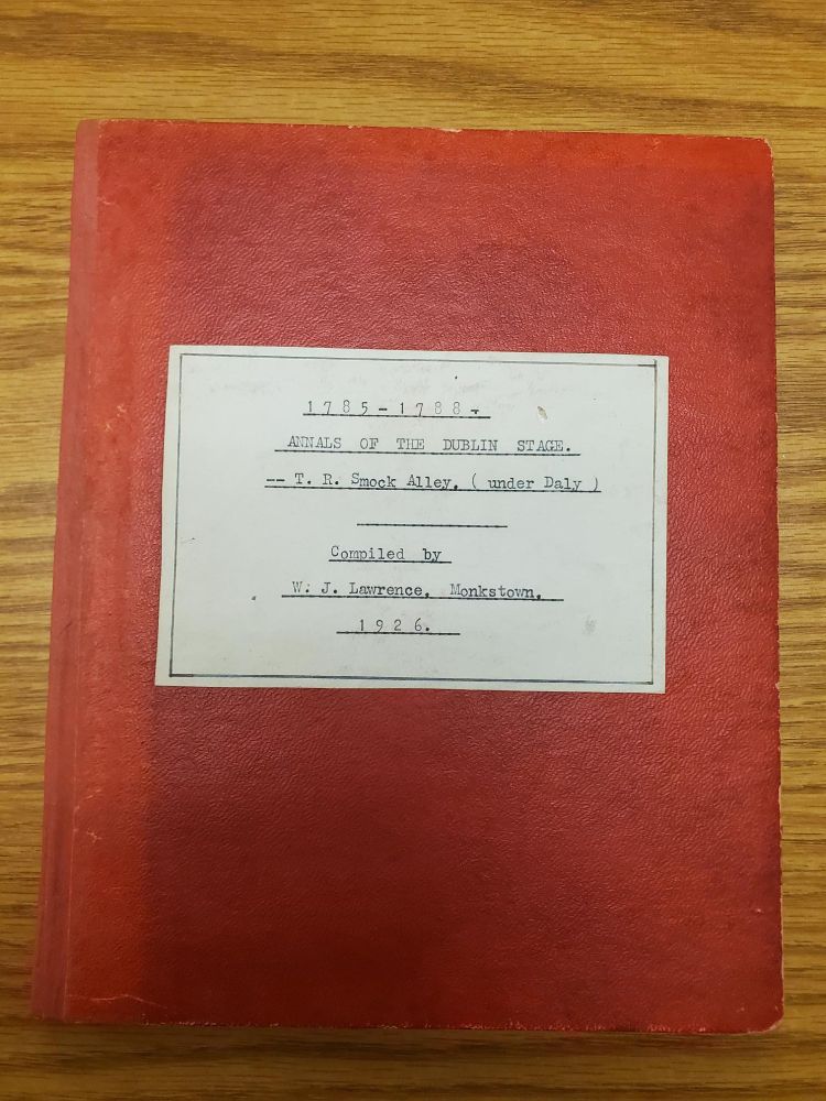 Front cover a a red notebook containing information on the history of theater in Ireland