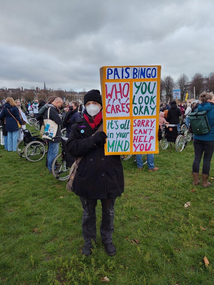 Picture of me at Pais Protest. With sign saying: Pais Bingo -  Who cares? - You look okay - It's all in your mind - sorry, can't help you. 
