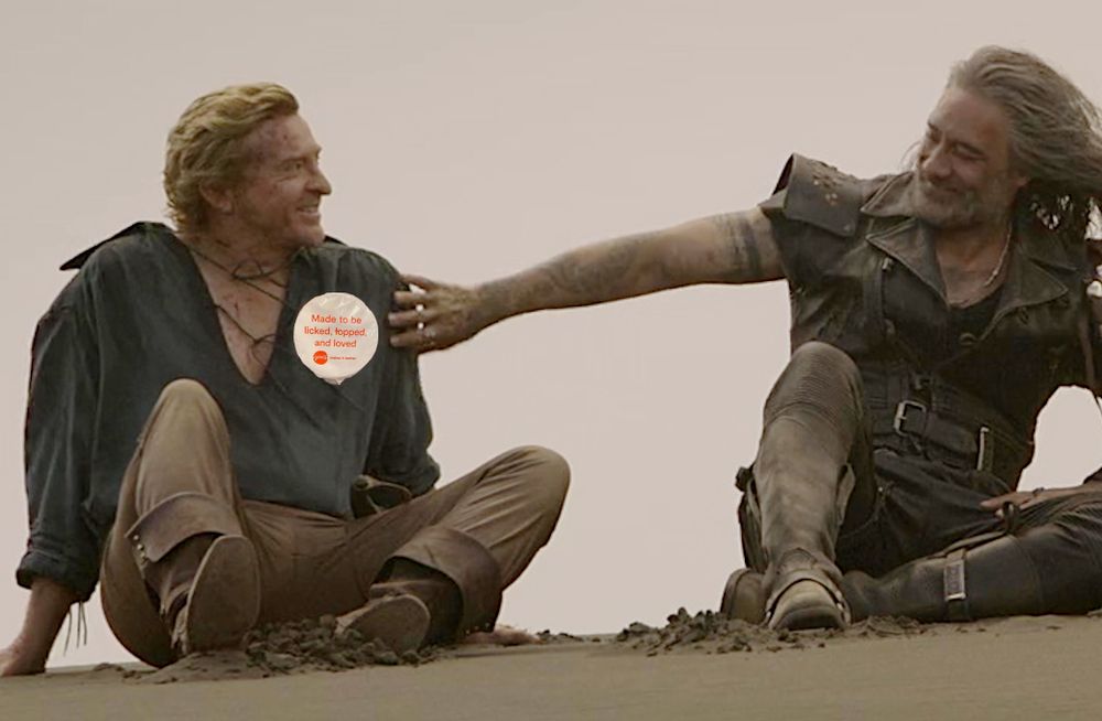 Stede sitting wearing the yoghurt label. Ed looks pleased with himself.