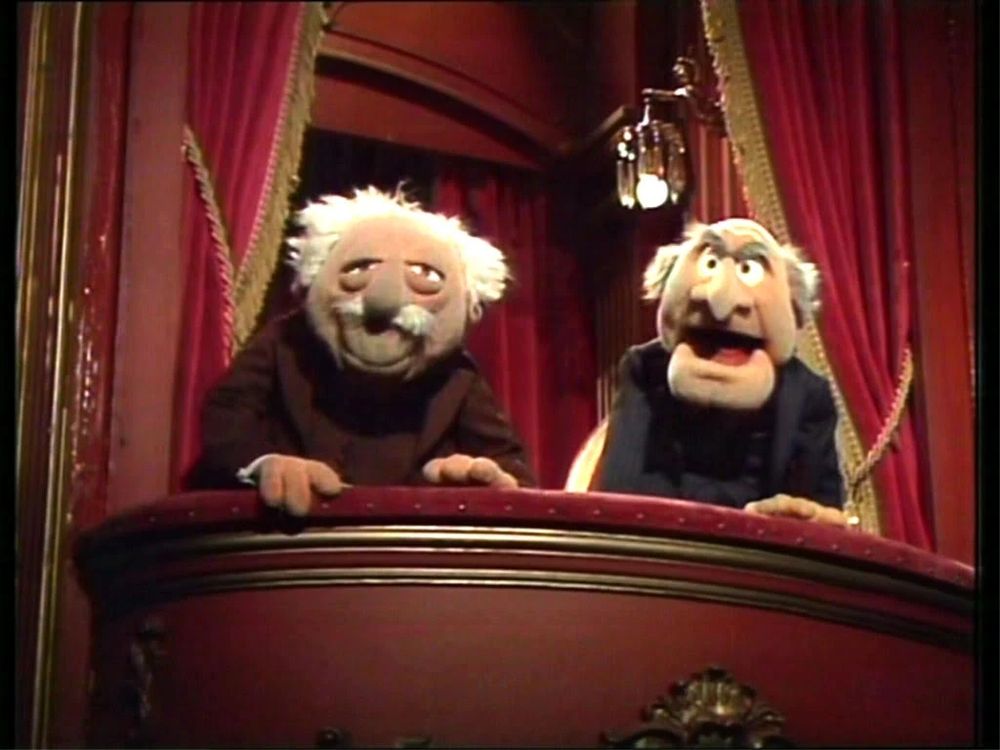 waldorf and Statler from the Muppet Show reacting to an amusing joke