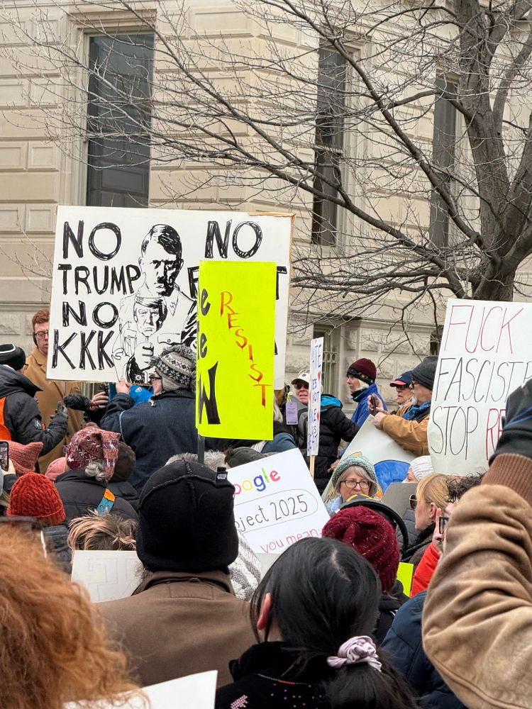 Person holding a sign at 50501 protest in Indianapolis that says No Trump, No KKK, No Fascist USA with pic of Hitler