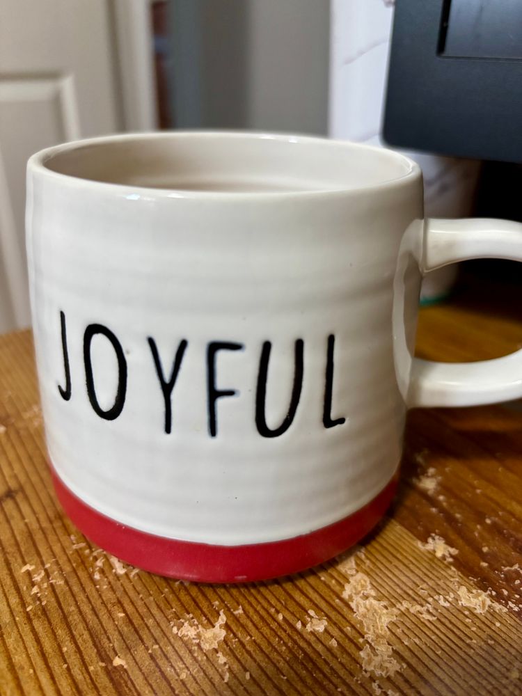 Red and white tea mug that says Joyful