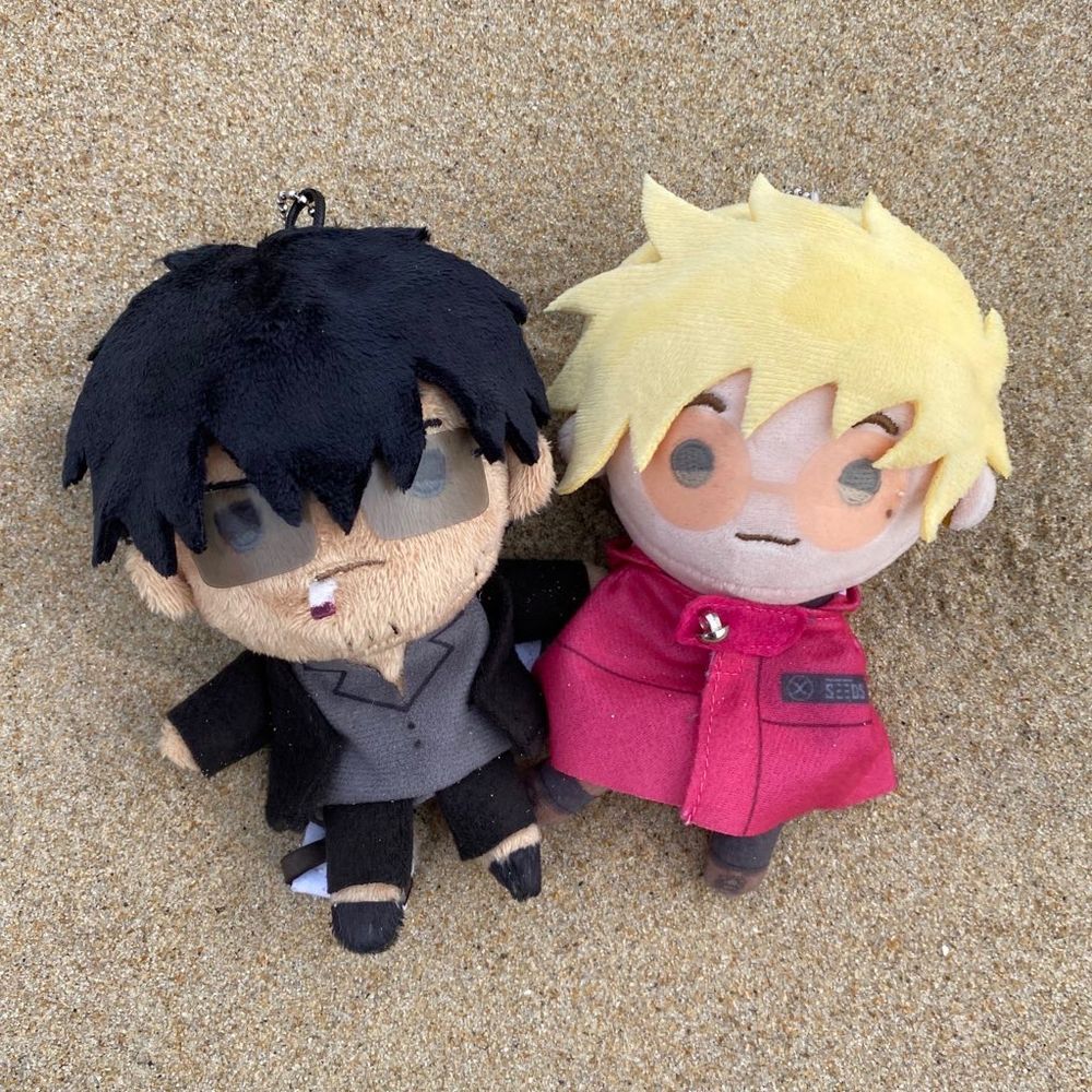 Teru Wolfwood (made by me) to the left of the official teru Vash, both on a sandy background