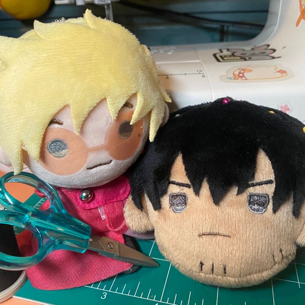 Teru Vash plush holding scissors next to prototype head of teru Wolfwood
