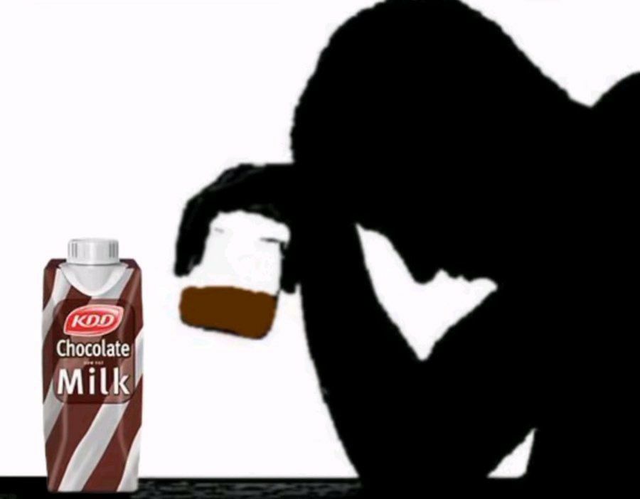 A silhouette of a tired and troubled man holding a glass of chocolate milk. He's taking the edge off. 