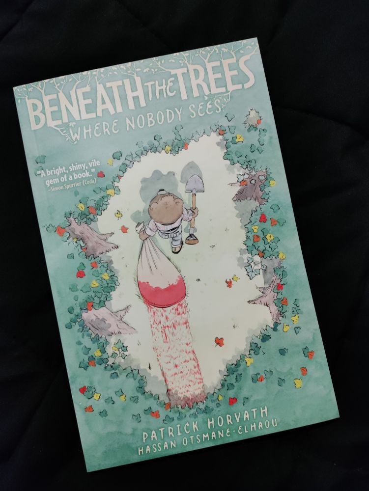 A comic book named 'Beneath the Trees Where Nobody Sees'. It has a character holding a shovel and dragging a big bag soaked in blood behind them through a forest. 